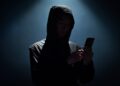 Hacker holding phone