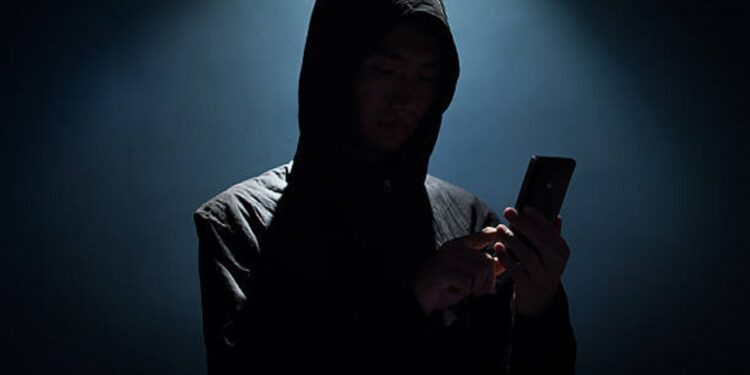 Hacker holding phone